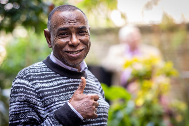 Man smiling with his thumb up